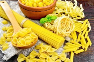 Pasta different with basil on dark board